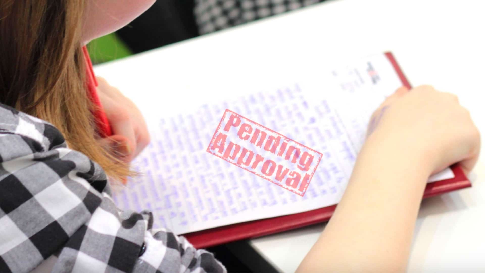 A student gets back an essay stamped "Pending Approval."